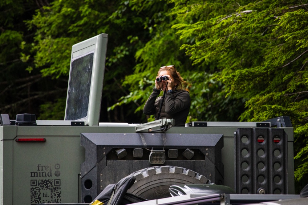 Ana on top of Tortuga with binoculars